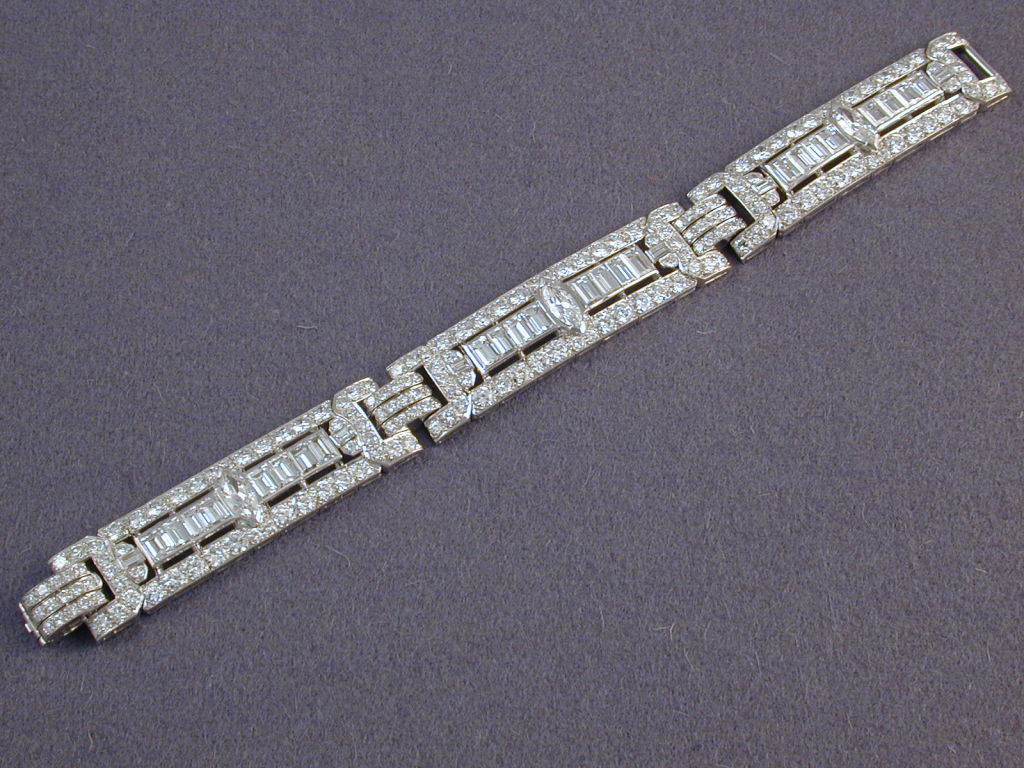 A very fine Art Deco diamond bracelet of three matching sections of baguettes, marquises and round diamonds set in platinum.