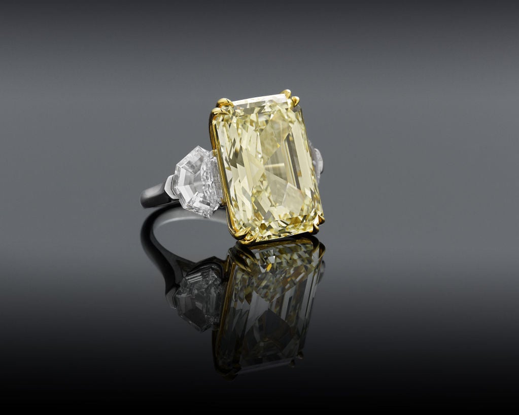 Weighing just over 20 carats, this absolutely breathtaking and highly important Natural Fancy Yellow diamond is among the most rare and desirable gemstones in the world. Set within platinum and 18K gold, this outstanding 20.05-carat jewel is paired