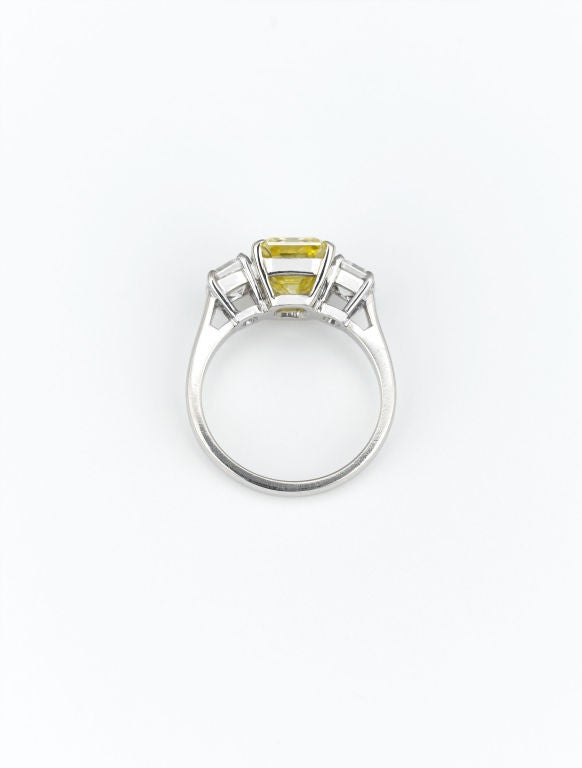 This dazzling and highly important 3.05-carat Natural Fancy Vivid yellow emerald-cut diamond exhibits the purest yellow possible, making it one of the most exceptional gemstones in the world. This incredible jewel sparkles with the fire and