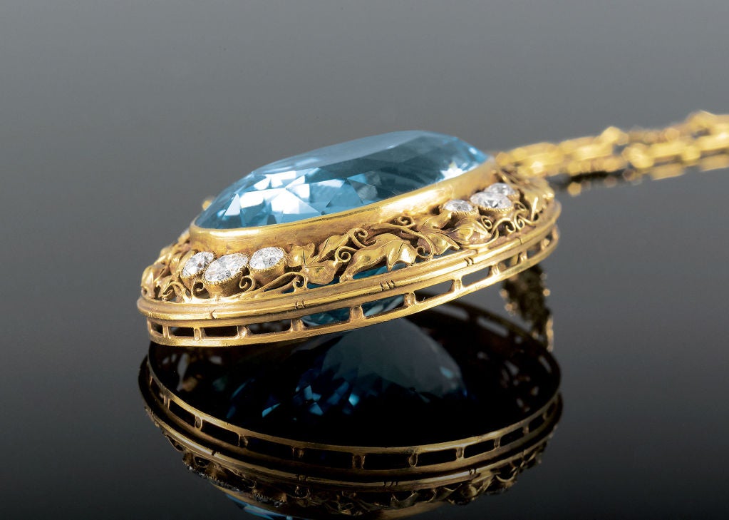 The 85-carat aquamarine in this stunning Arts and Crafts-era necklace by jewelry designer Edward Everett Oakes boasts the vibrant blue color so desired in this exquisite jewel. The entire 18K yellow gold necklace, from the fancy-linked chain to the