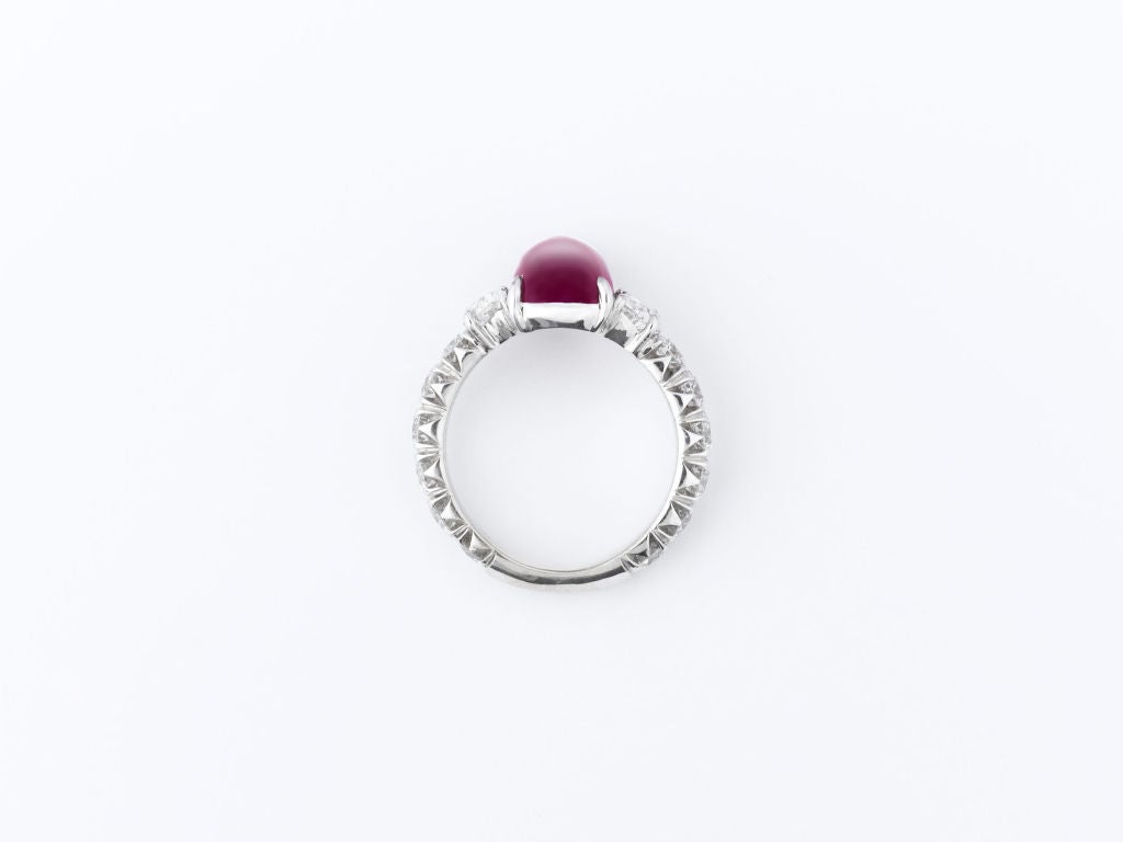 Exceptional color and depth set this outstanding natural Burma ruby apart. Weighing 5.41 carats, this exquisite cushion-shaped cabochon exhibits an eye-catching, smoldering red hue; its intensity enhanced by the stone’s rare, deep cut. Though many