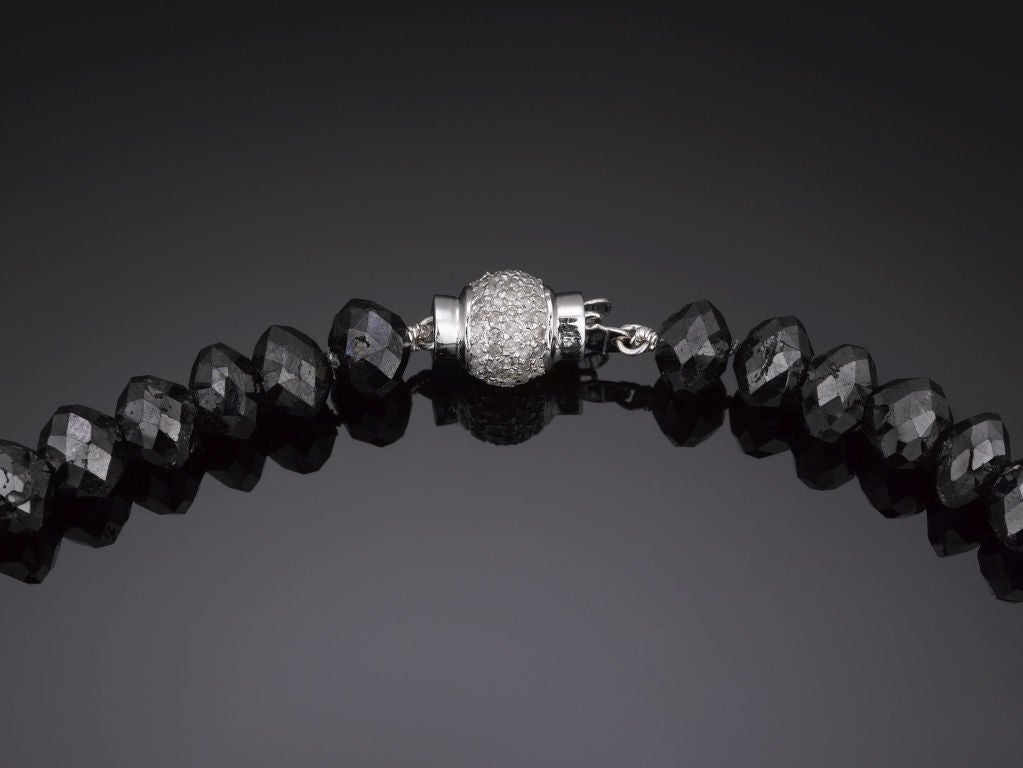 This elegant necklace combines the striking beauty of black diamonds with the sparkle of white diamonds and gold. Showcasing an incredible 245.64 carats of expertly faceted, briolette-cut black diamond beads, this necklace is secured with an 18K