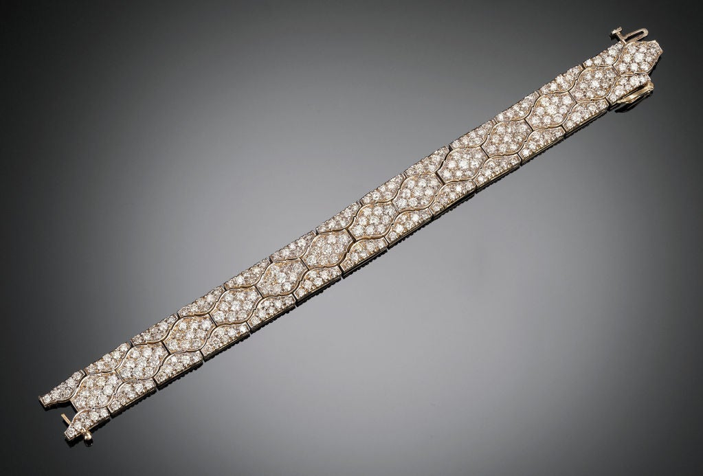 This exciting diamond bracelet boasts approximately 23.00 carats of brilliant round-cut diamonds set in an elegant arabesque design. This 14K yellow gold bracelet is held securely with a box catch. 
7? length