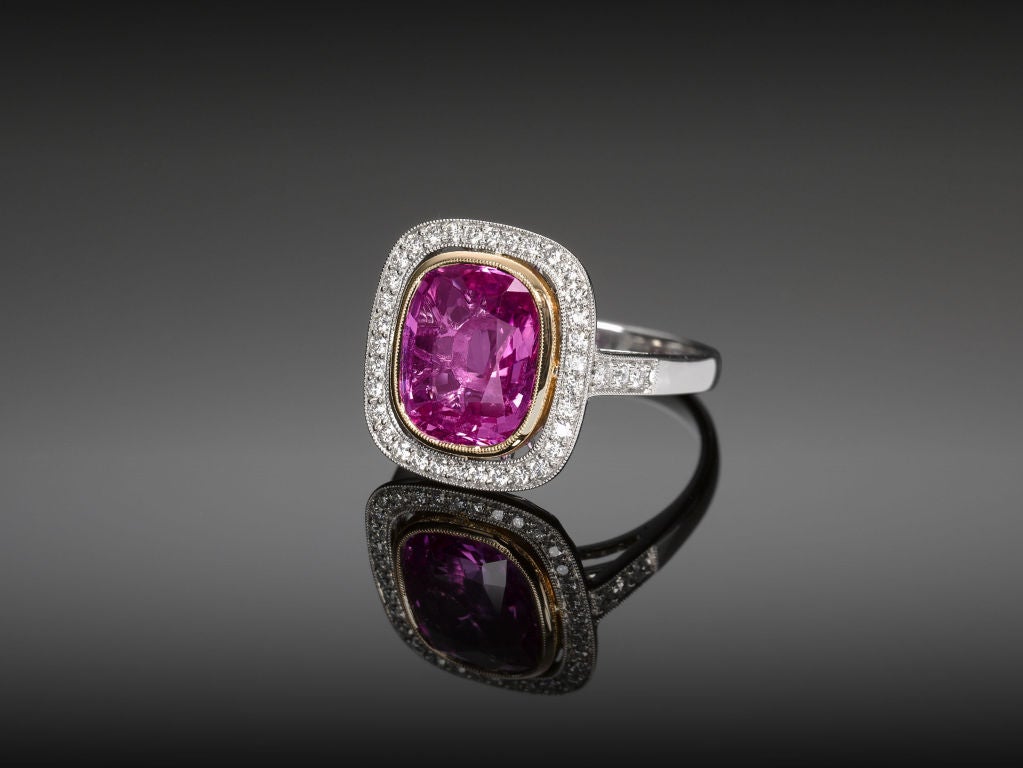 This enchanting 4.32-carat pink sapphire is encircled by .31 carats of white pavé diamonds and set in a platinum and 18K yellow gold mounting. The sapphire is certified by GemResearch Swisslab (GRS) to be Natural with no heat treatment.<br><br><a