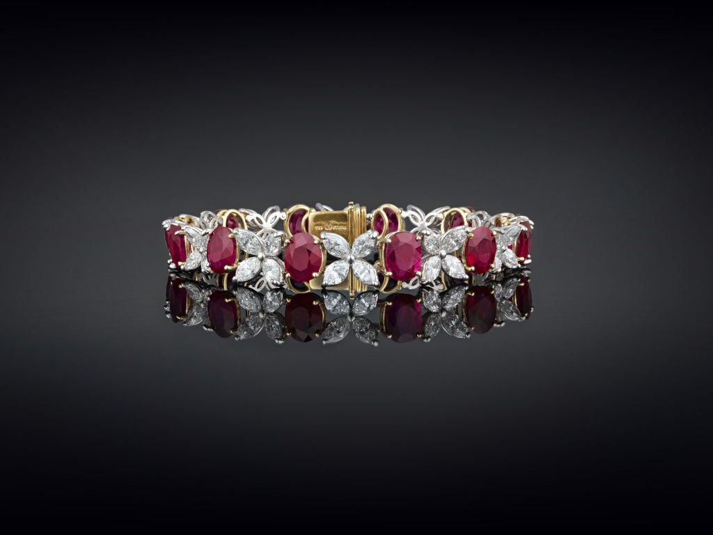 Twelve exceptionally rare, untreated Burma rubies are set within this luxurious bracelet. Weighing 22.85 total carats, these rich crimson gemstones exhibit the majestic 