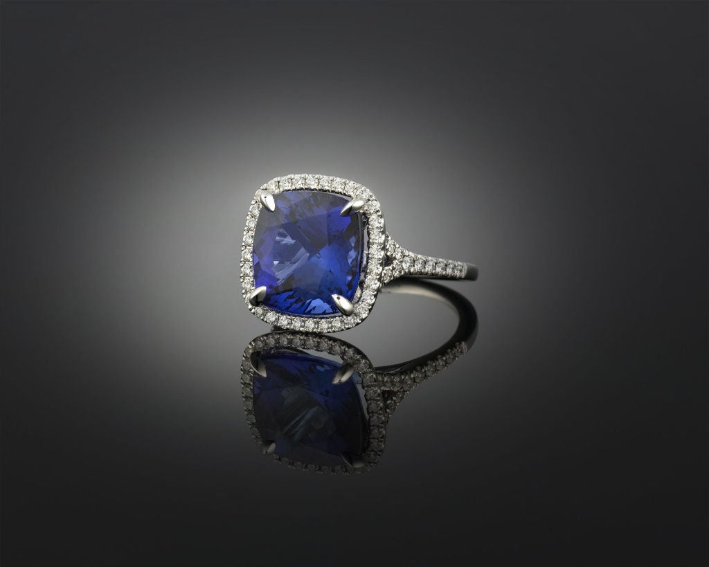 An opulent and rare 7.72-carat tanzanite is the star of this sophisticated ring. Boasting the outstanding, purple-tinged blue hue for which tanzanites are so coveted, this important gemstone’s flawless cushion shape showcases its wonderful color.