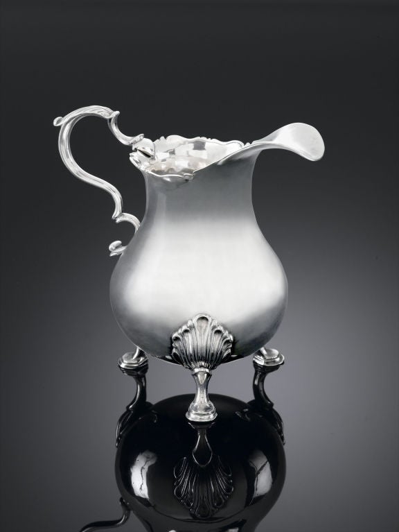 An elegant antique American silver cream pitcher by renowned New York silversmith Myer Myers. Hailing from Myers' desirable, early Rococo period, the three-footed design was only made during a very short-lived time in his career. An understated and