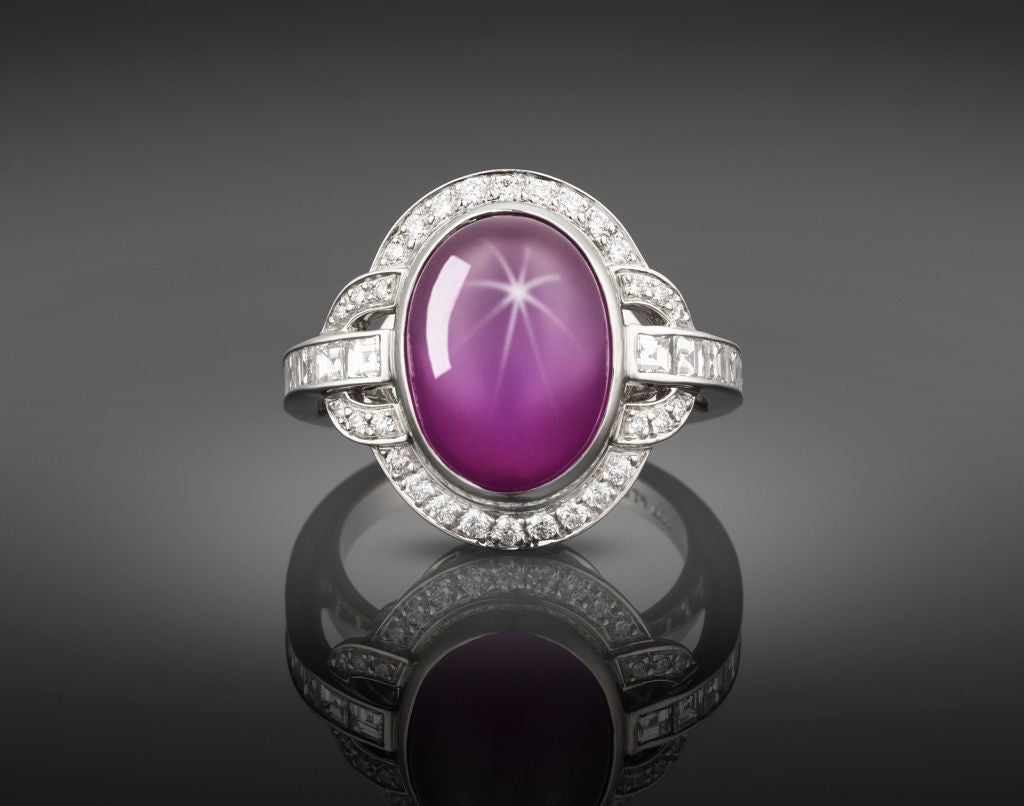 A rare and stunning Natural star ruby commands attention in this extraordinary ring by Tiffany & Co. The eye-catching oval double cabochon, weighing 11.70 carats, exhibits a perfect six-point star in reflected light, a rare phenomenon known as