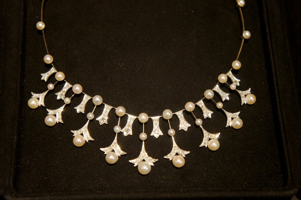 This Antique Necklace by Mikimoto displays an early example of Cultured Pearls. The necklace, fashioned in an earlier Edwardian style, uses platinum over gold in a very fine 