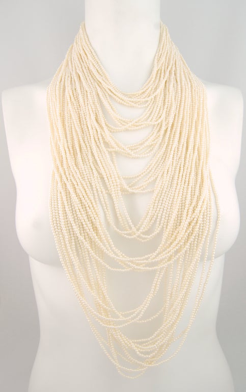 Sumptuous bib necklace featuring over 50 strands of faux pearls in cascading lengths.

Signed Marvella