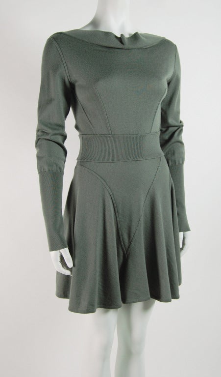 Soft and luxurious wool jersey dress with long sleeves, flounce skirt and open back. Classic Alaia style in a dusty moss green color.

100% Virgin Wool

Note that fabric has some stretch. Waist fits up to 26