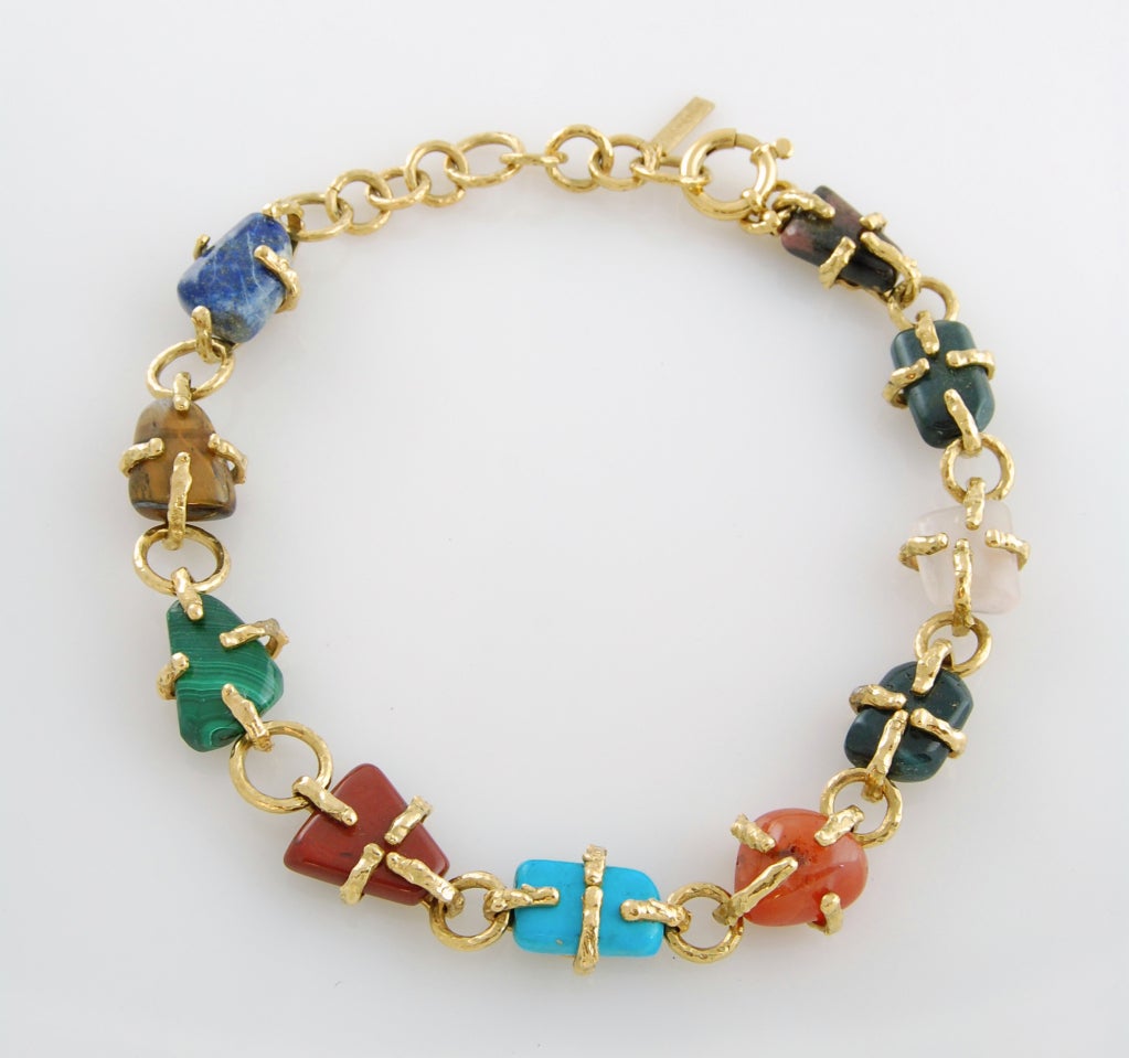 Go tribal luxe to the max with this Yves Saint Laurent hammered link necklace featuring link-wrapped semi-precious polished nuggets of lapis lazuli, malachite, turquoise, red jasper, quartz, rhodonite, and coroline stones, with heart detail on