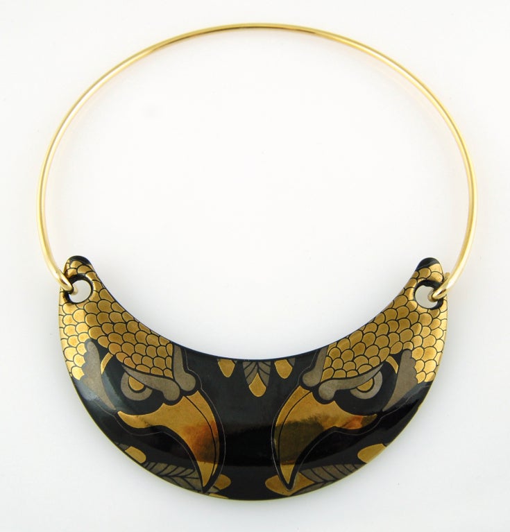 Franco Bastianelli de Laurana was a noted Italian designer who worked primarily in enamels. This 1960's necklace features a black ceramic plate with a stunning double falcon graphic rendered in metallic gold and matte bronze enamel. A single metal
