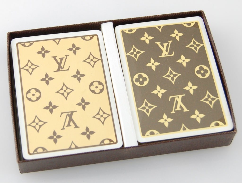 Two decks of gold-edged fine playing cards with LV monogram print backs are housed in an elegant carrying box, perfect for gift giving! Cards are sealed. 

This is an out-of-print design!