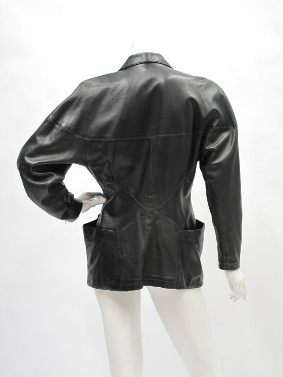 Azzedine Alaia edgy black leather blazer with zip cuffs and wrap-around hip pockets.
