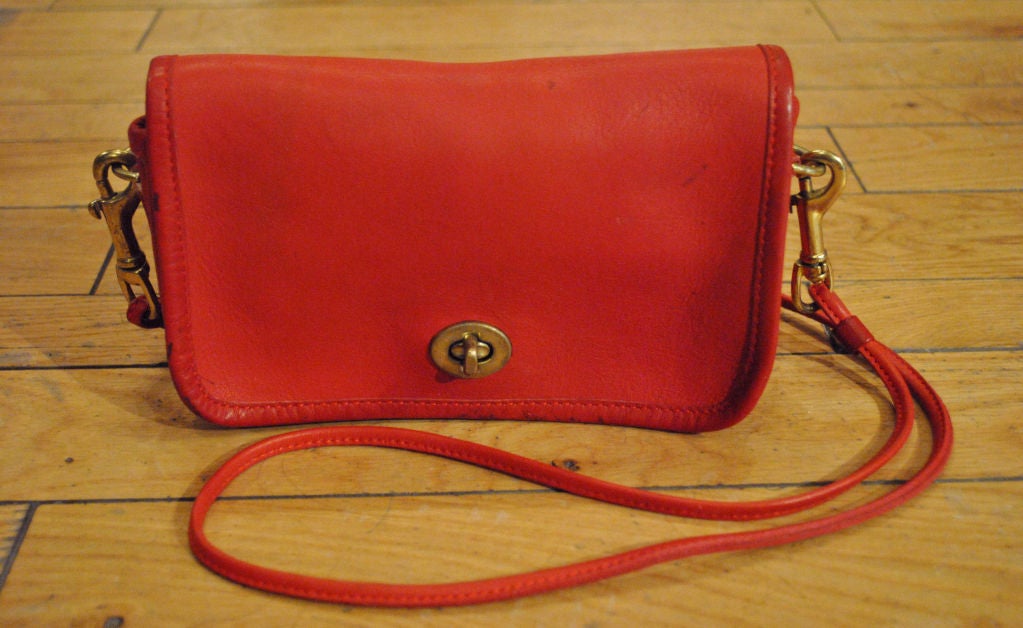 Fantastic vintage Bonnie Cashin Coach purse.  Vibrant red leather with long thin strap, brass hardware and change purse inside.  Classic high quality piece!  Measures 8