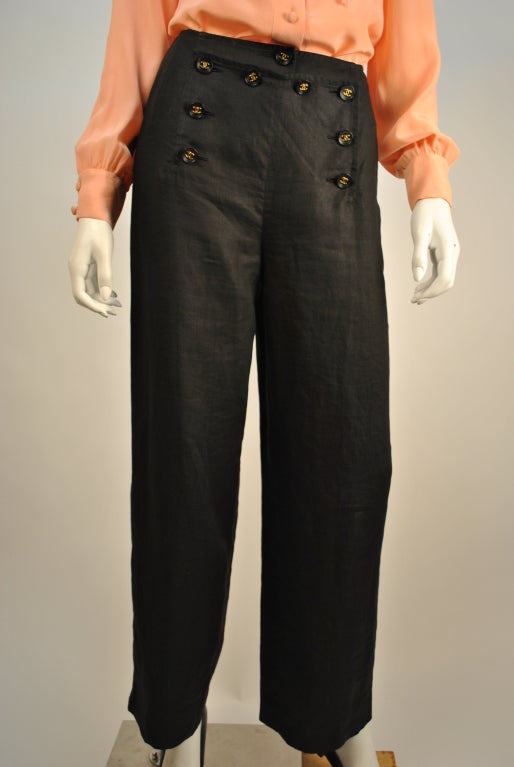 Gorgeous 1980's Chanel black linen sailor slacks w/gold logo buttons feature a straight leg cut which are cropped at the ankle. These Chanel pants are as comfortable as they are stylish.