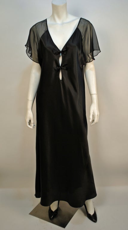 Vintage Valentino 100% silk black sheer bow night gown reminds us of an era when women lounged in comfort and ultimate style. This gorgeous gown has a stunning bow tie detail at the bust and lovely sheer back and shoulders creating a very sexy