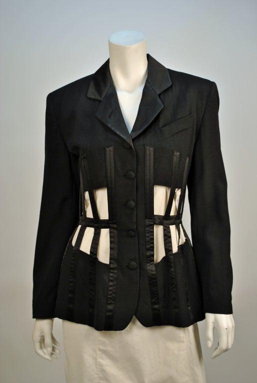 Vintage Jean paul Gaultier black cut out corset cage blazer is a gorgeous well crafted piece. The cut out detail is so beautifully constructed on this jacket, the shape it creates will be sure to turn heads!