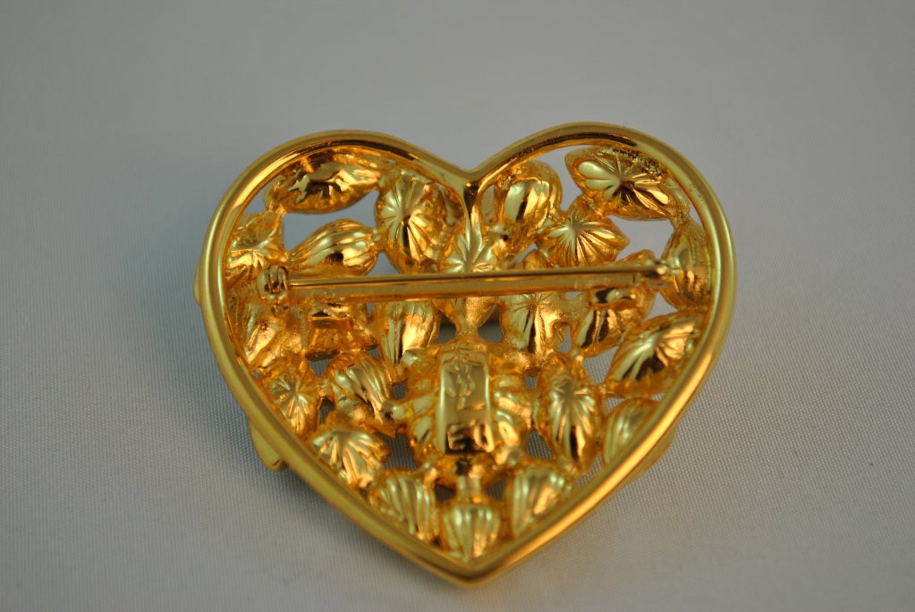 Lovely YSL bejeweled heart shaped brooch, with pin back closure. Very romantic!! Measures 2 1/4 inches X 2 1/2 inches.