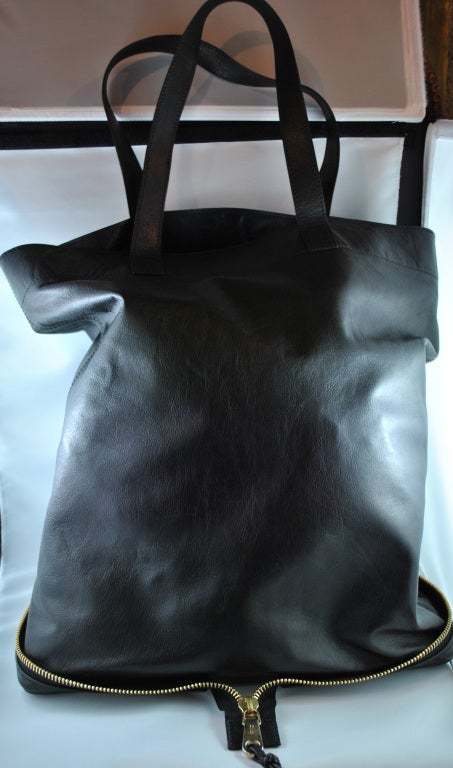 Super nice black leather tote shopper by Chloe. Gold color hardware zips up into a small hand take-a-long. Closed size 5X6 inches, open size approx 16X16 inches.