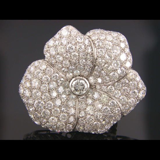 From the SHREVE,CRUMP & LOW Estate Collection. Platinum pin in the shape of a flower with 171 round brilliant cut G VS2 diamonds with a total weight of 8.50 carats, bead set over whole surface of each petal and a bezel set diamond in the center.