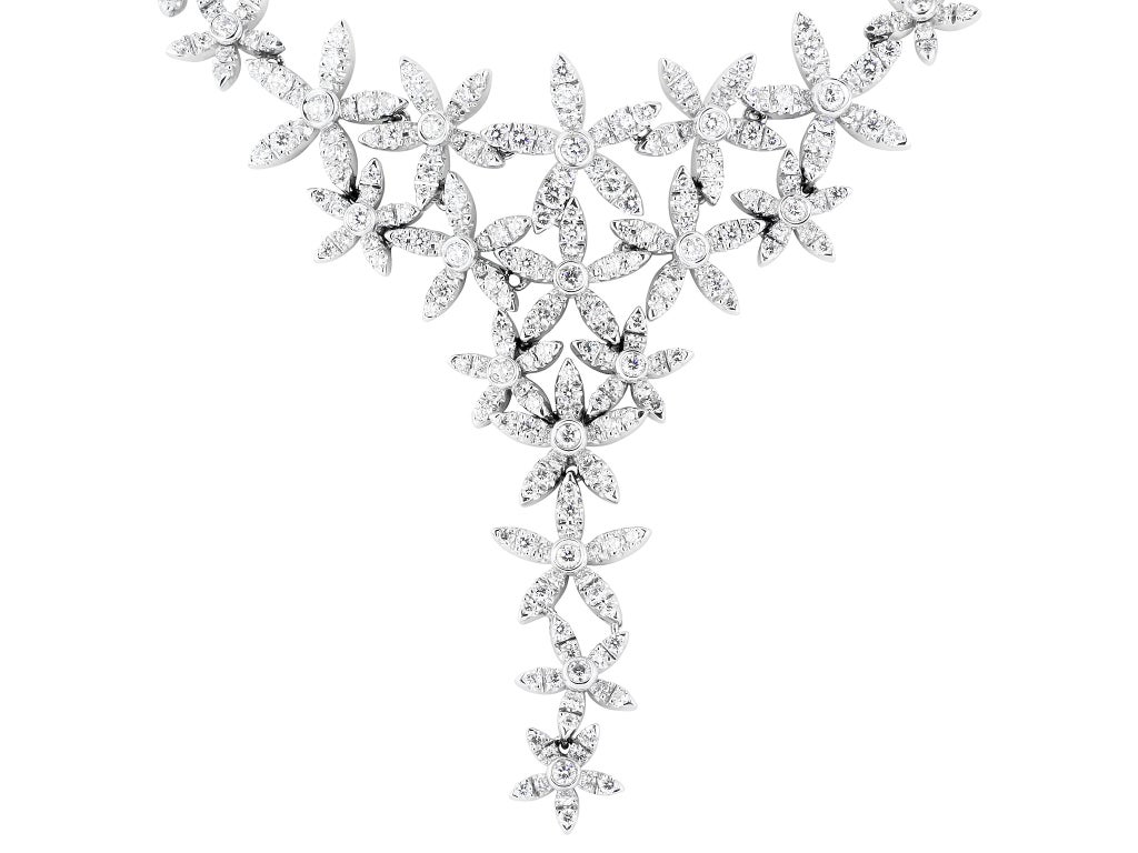 18 karat white gold floral motif open work necklace consisting of 14.85 carats total weight of round brilliant cut diamonds, signed Asprey.
