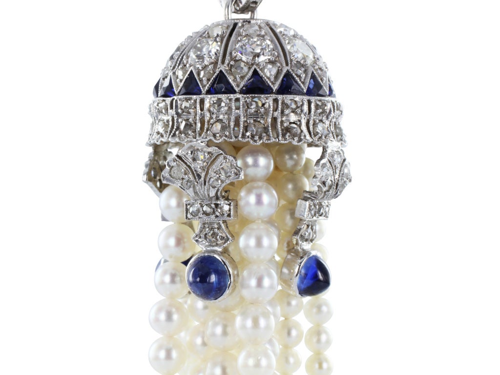 Platinum vintage seed pearl tassel pendant set with Old European cut diamond and custom cut sapphire accents.