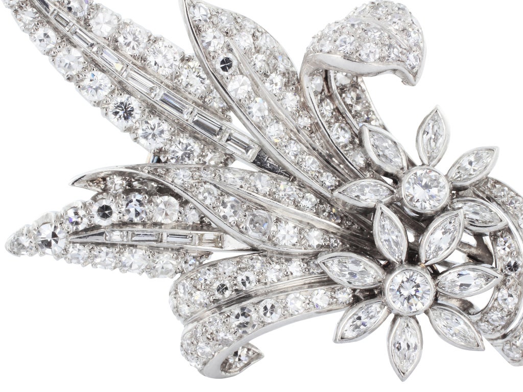 Platinum floral bouquet pin from Garrard & Co, consisting of 129 Old European and single cut diamonds , 12 marquise cut diamonds and 25 baguettes having a total weight of approximately 1.25 carats. The back is numbered W54071 and the pin is in its