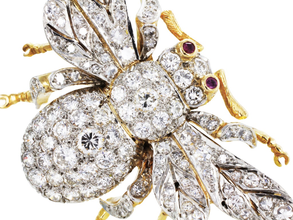 Platinum and 14 karat yellow gold bee estate pin consisting of 106 pave set Old European and single cut diamonds having a total weight of approximately 5.00 carats set with 2 bezel set ruby eyes.