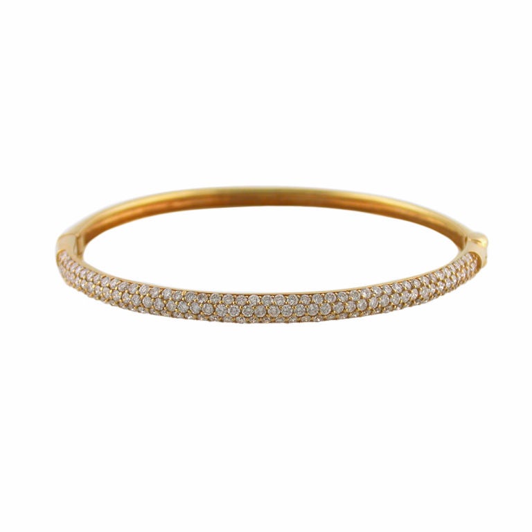 Stunning 18kt yellow gold rounded bangle with pave set diamonds, and hinge.
The price is approx. $6,500.00

Shreve, Crump and Low is renowned for the beauty and high quality of its merchandise, as well as its 215-year-old reputation of elegance