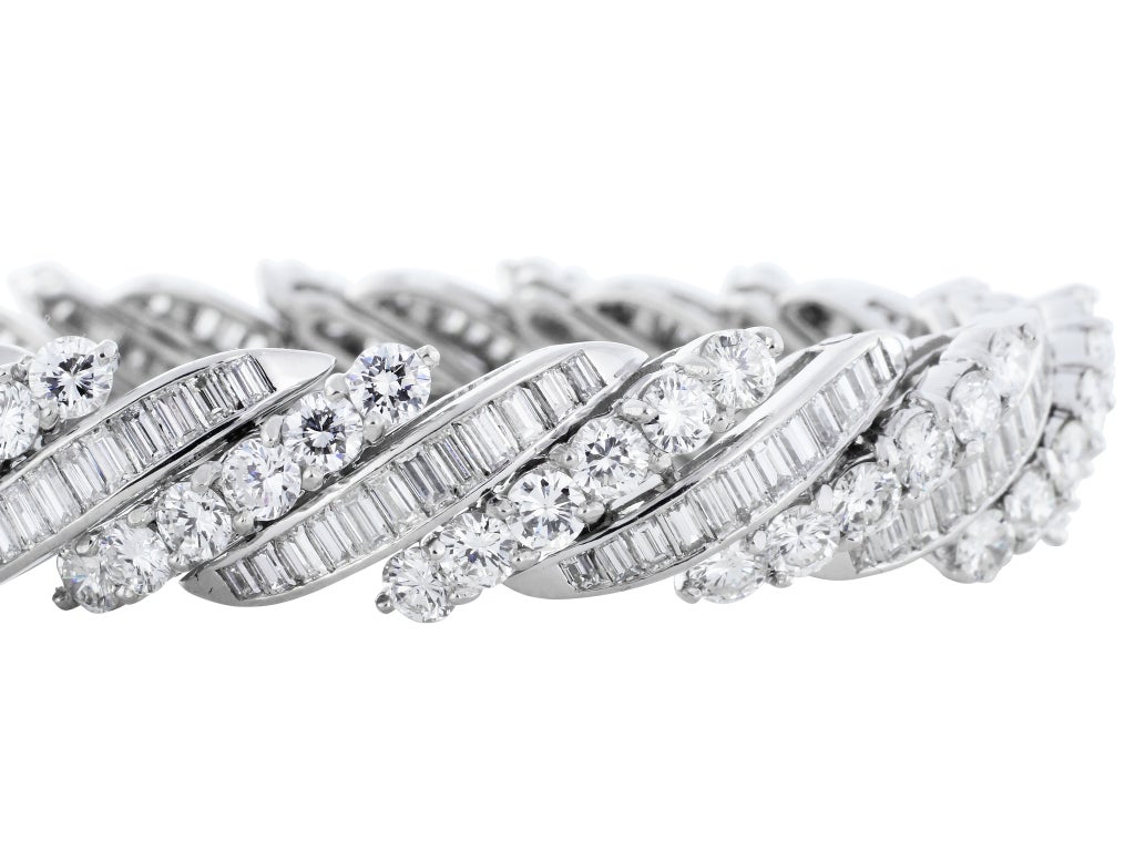 Platinum vintage barber pole style bracelet consisting of 90 round brilliant cut diamonds and 180 custom cut baguette cut diamonds having a total weight of approximately 15.00 carats having a color and clarity of F-G/VS2-SI1 respectively.
