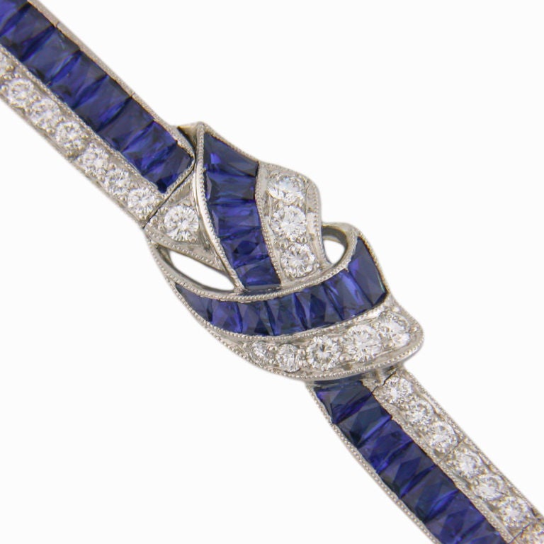 Elegant French Ribbon Bracelet, consisting of gem white round brillant cut diamonds, and french cut sapphires set in solid platinum.  A timeless bracelet from a timeless American company that sets the precedent of classic style.  This bracelet is