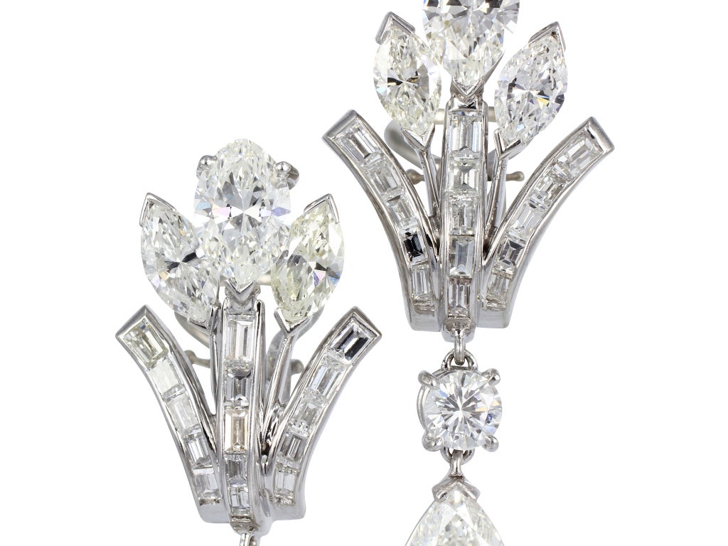 Platinum Retro diamond cluster style drop earrings, consisting of 2 pear shape diamond drops 1 weighing 1.03 carats  with GIA report 2131690430 and 1 pear shape diamond weighing 1.01 carats with GIA report 1125158128 and both having a color a H/VS2.