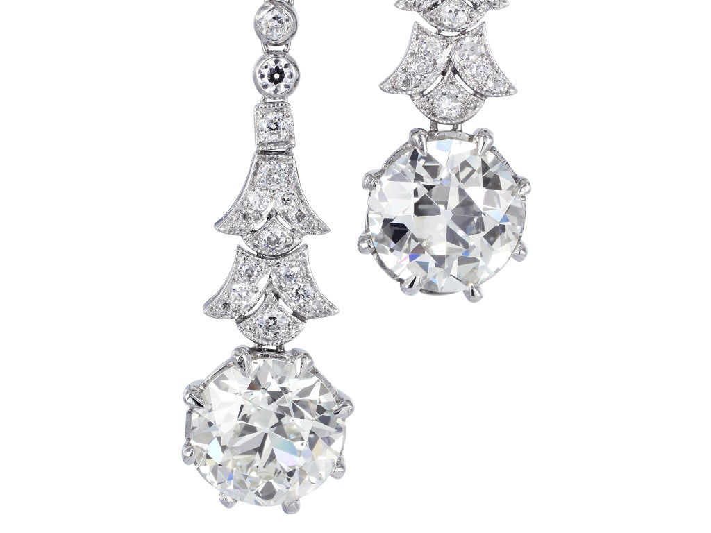 Platinum Edwardian style drop earrings featuring 2 old European cut diamonds having a total weight of 5.36 carats and approximate color and clarity of I-J/VS2 total weight dropping from 2 old European cut diamonds having a total weight of 1.64