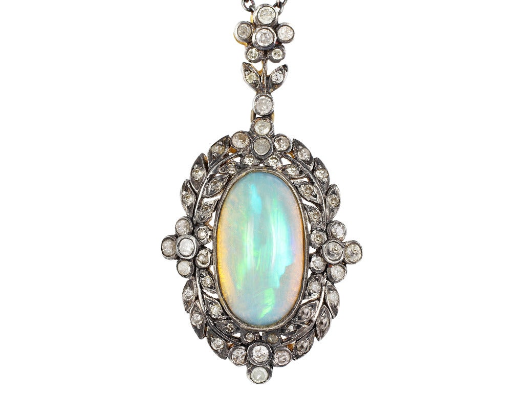 Edwardian 14 karat yellow gold and sterling silver opal and diamond pendant.