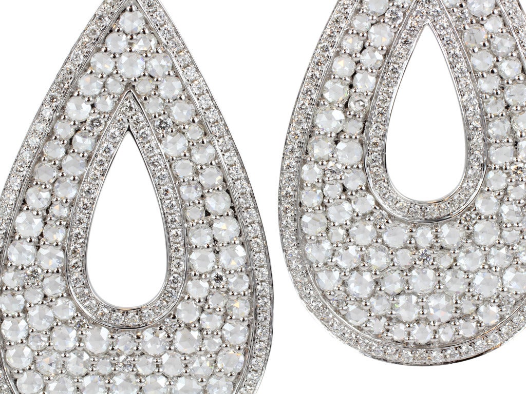18 karat white gold tear drop earrings consisting of 4.33 carats total weight of rose cut diamonds set with 1.36 carats total weight of round brilliant cut diamonds.