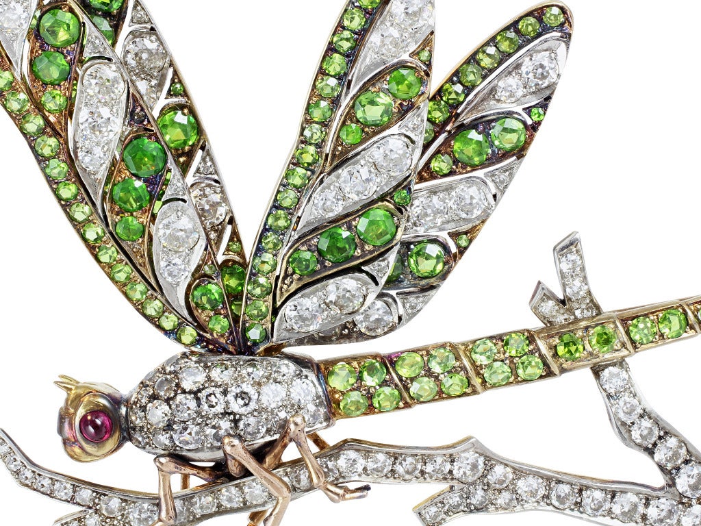 Platinum and 18 karat yellow gold dragonfly pin consisting of 6.95 carats total weight of Old European cut diamonds set with 6.30 carats total weight of demantoid garnets and cabochon ruby eyes.