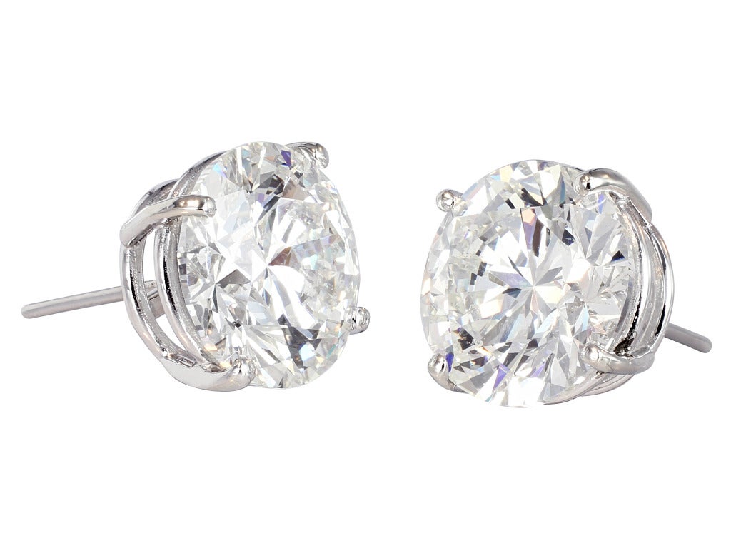 Platinum stud earrings consisting of 2 round brilliant cut diamonds one weighing 6.00 carats having a color and clarity of J/SI2, measuring 11.54 - 11.63 x 7.16mm with GIA certificate #1122937618 and one weighing 6.02 carats with having a color and