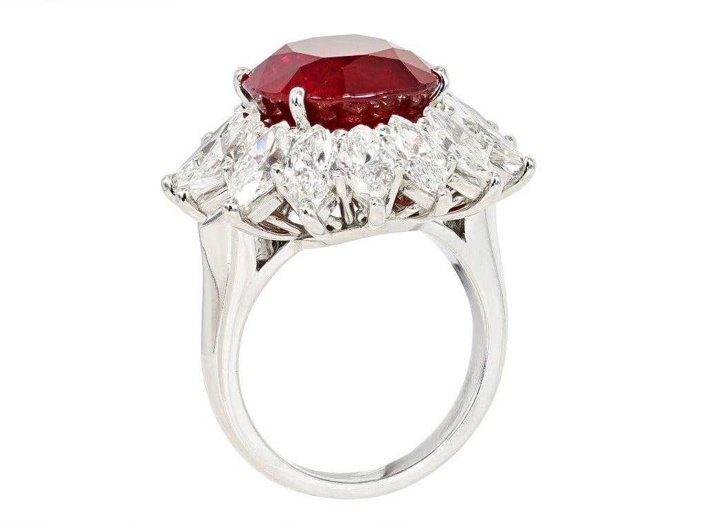 Platinum cluster ring consisting of 1 cushion cut Thai ruby weighing 10.33 carats, measuring 12.54 x 11.91 x 7.90mm with GIA certificate 2151270828, the center stone is surrounded by 1 row of marquise shape diamonds having a total weight of