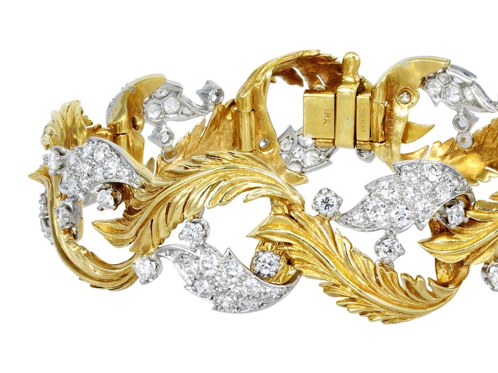 This beautiful Retro Two tone platinum and 18 karat yellow gold leaf motif
open work flexible bracelet consists of 150 Old
European cut diamonds having a total weight of
approximately 4.50 carats, ca. 1950.