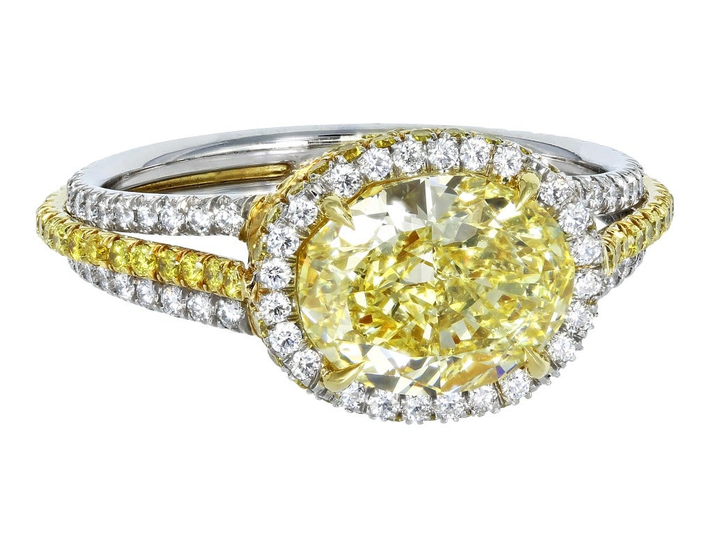 Platinum and 18 karat yellow gold solitaire ring
consisting of one horizontal set oval shape natural
canary diamond weighing 2.31 carats having a
color and clarity of FY/VS1, measuring 9.03 x 7.12
x 4.51mm, with GIA certificate #15831492,