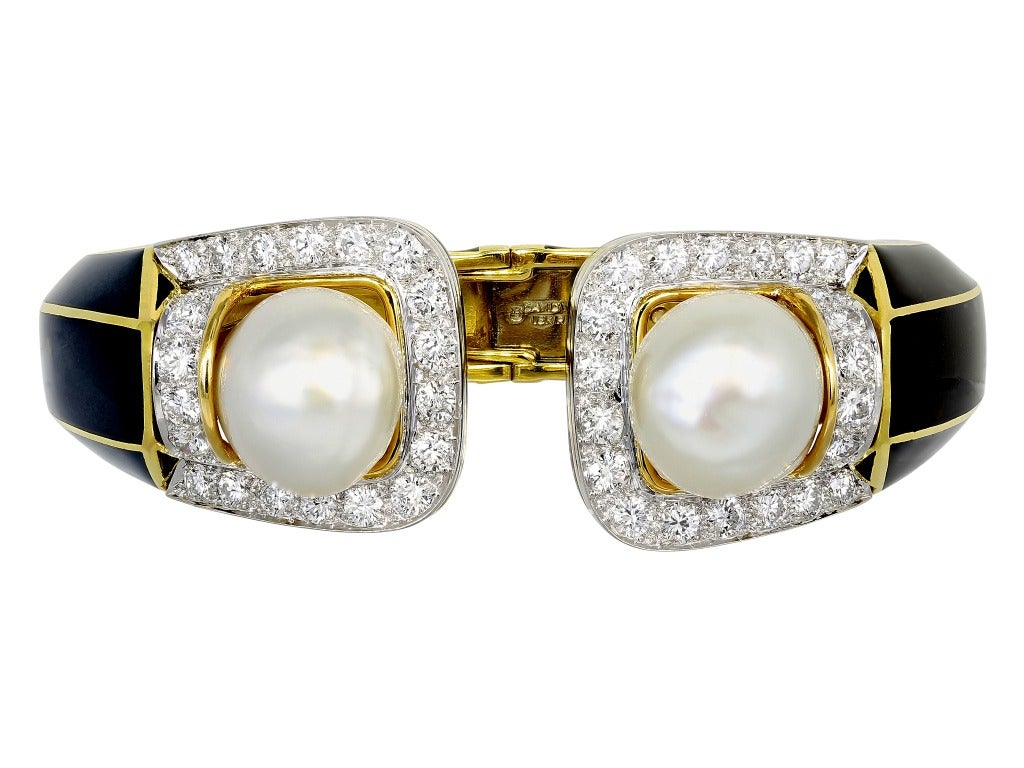 Platinum and 18 karat yellow gold semi flexible black enamel cuff bracelet  set with approximately 5.10 carats total weight of round brilliant cut diamonds and two 15mm baroque pearls, signed David Webb.