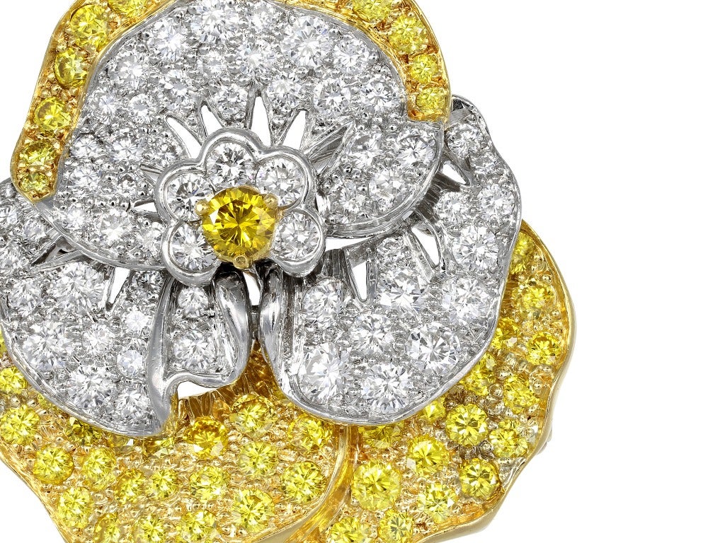 Estate Oscar Heyman Bros platinum and 18 karat yellow gold pansy pin set with colorless diamonds having an estimated total weight of 2.25 carats and natural canary round brilliant cut diamonds having an estimated weight of 2.15 carats, signed