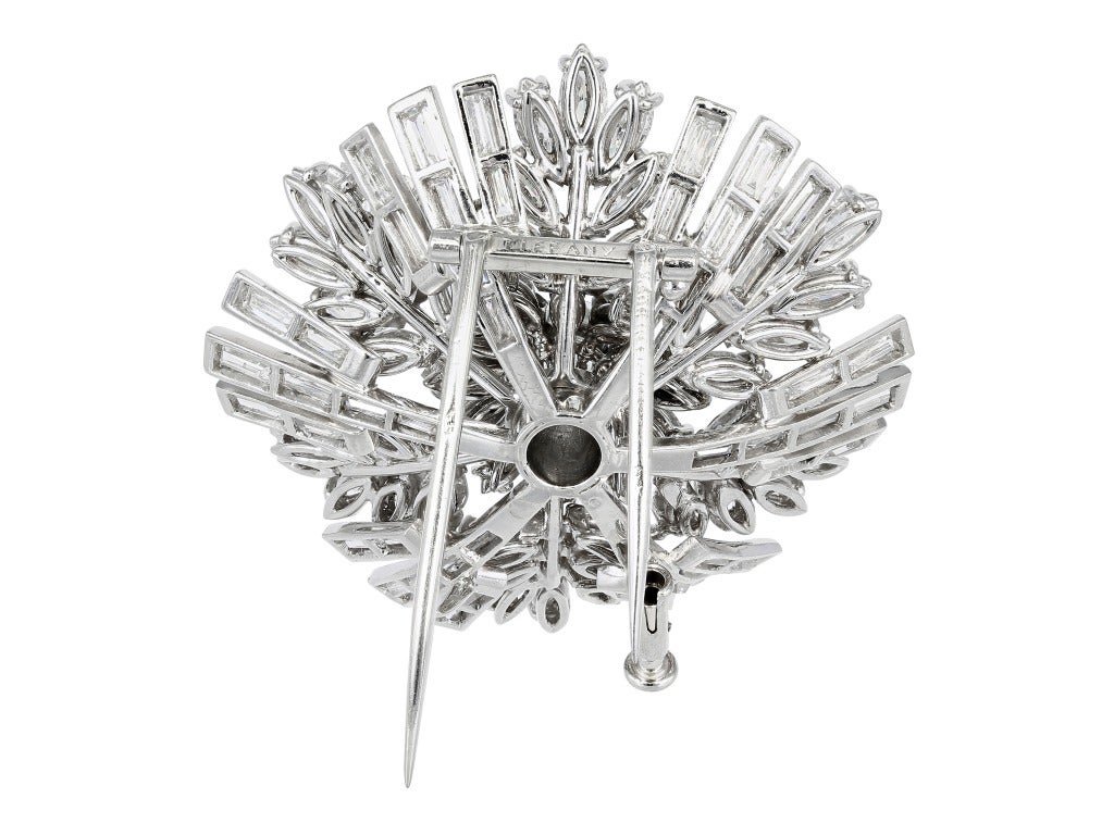 Platinum open work estate flower pin consisting of approximately 15.00 carats total weight of round brilliant cut, baguette and marquise diamonds, signed Tiffany made in France, Circa 1930.