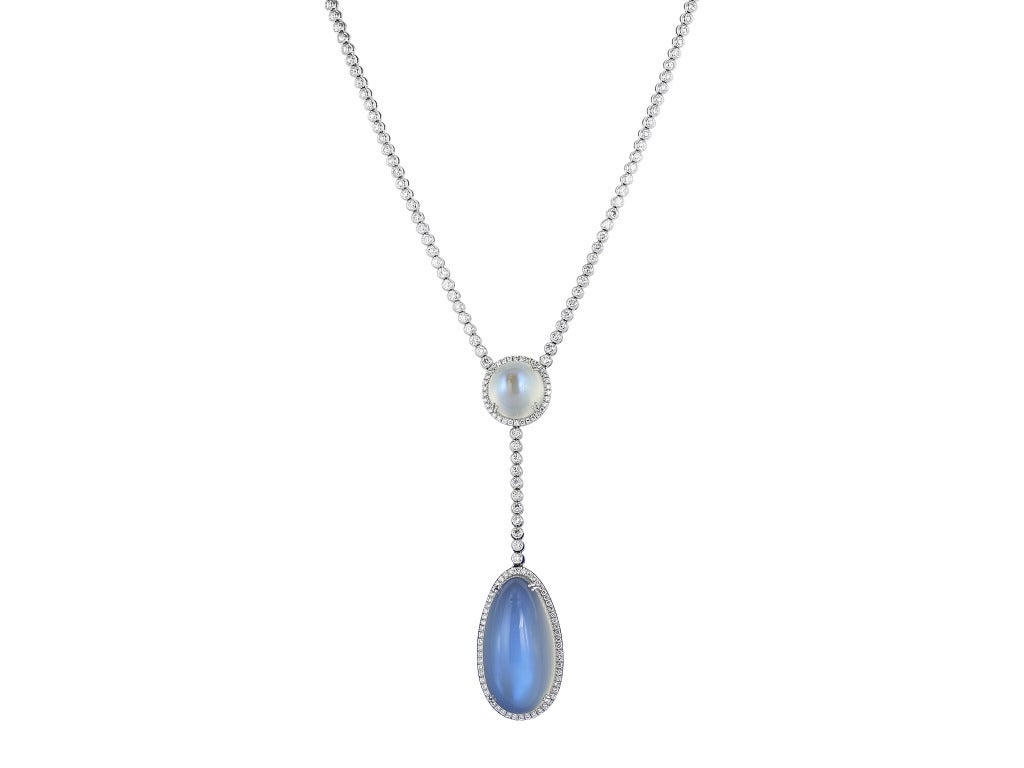18 karat white gold necklace consisting of one pear shape cabochon moonstone weighing 77.93 carats and 1 round shape cabochon moonstone weighing both having a combines total weight of 94.59 carats, the stones are set with 214 round brilliant cut