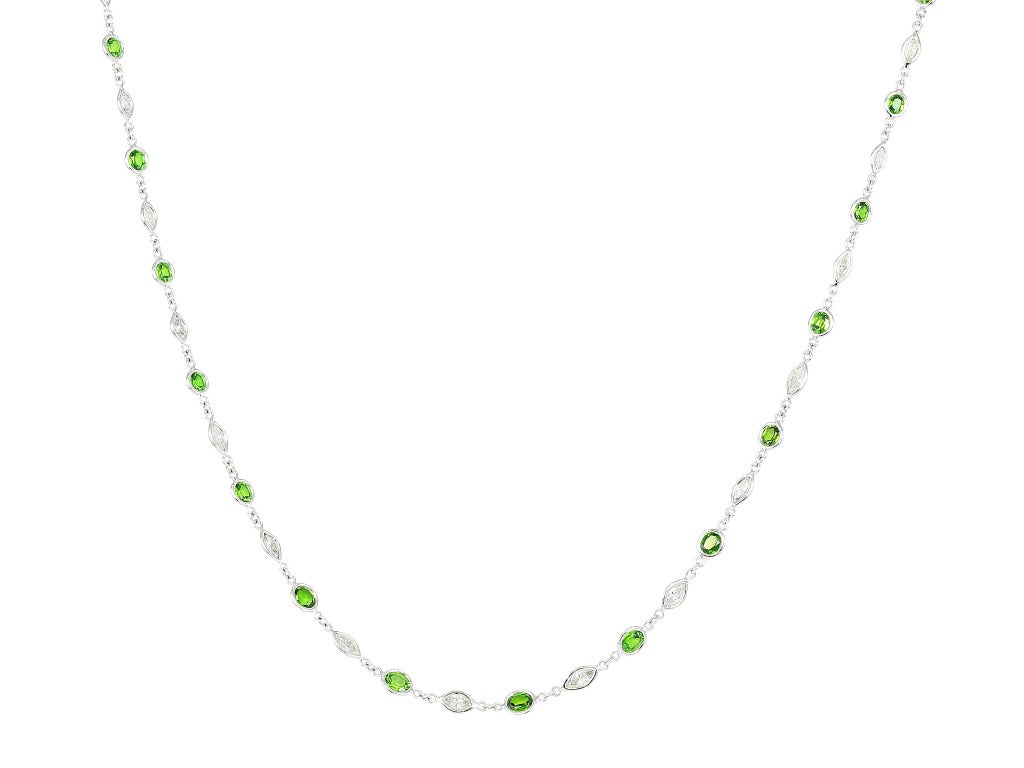 18 karat white gold by the yard style chain set with 31 full cut and oval shaped Demantoid garnets alternating with 31 marquise shaped diamonds