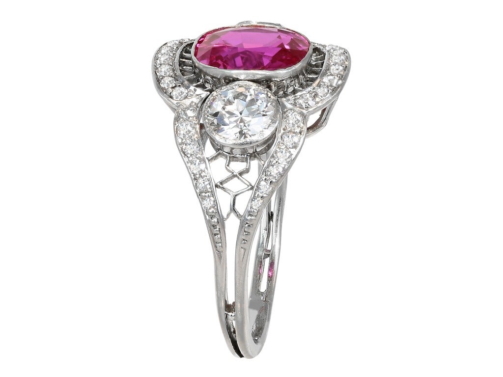 Platinum custom made 3 stone ring consisting of 1 cushion cut Burma ruby weighing 3.07 carats, measuring 8.58 x 8.53P x 4.49mm with AGTA certificate #98022509, the center stone is flanked by 2 old European cut diamond having a total weight of 1.80