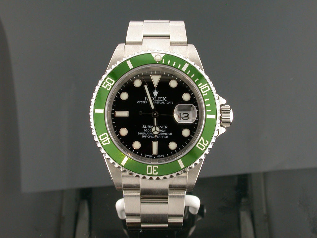 Rare Rolex stainless steel Submariner date 50th anniversary edition. The watch has a 40mm case, a green time lapse bezel, black dial and oyster fliplock bracelet. Water resistant to 1000 feet. This timepiece was produced in extremely limited