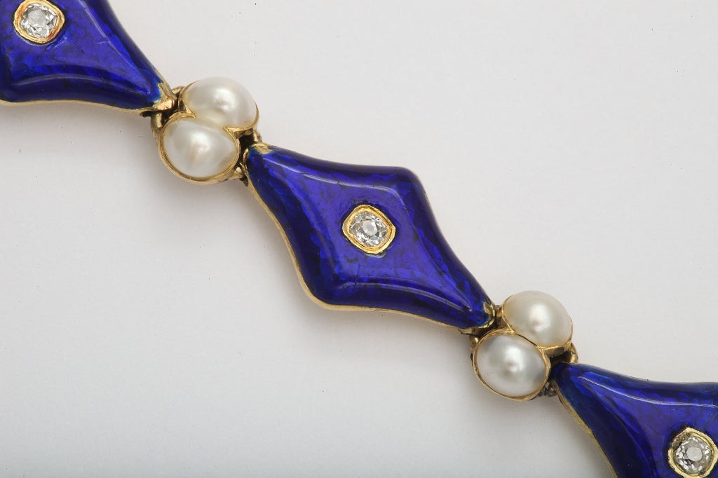 A beautiful Victorian 18K yellow gold and blue enamel bracelet is set with pearls and diamonds.

Estimated diamond weight: 0.50ct